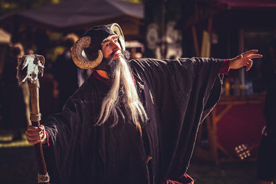 Man wearing costume standing outdoors