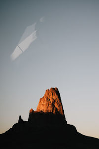 Low angle view of rock formation against sky