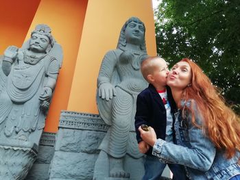 Happy woman looking at sculpture