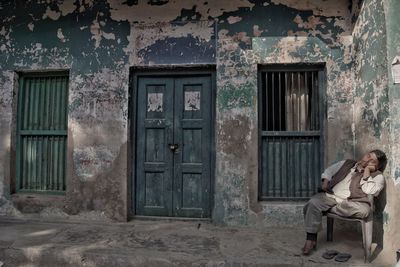 Woman sitting outside building