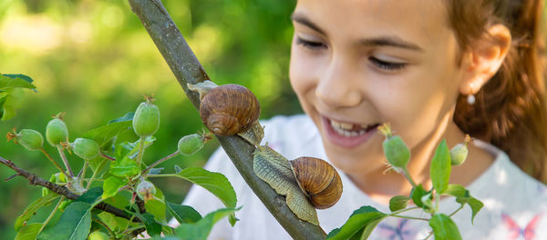 Close-up of young woman holding plant