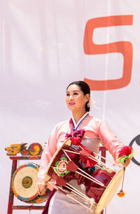 Portrait of young woman holding umbrella