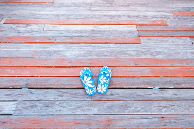 High angle view of shoes on wooden pier