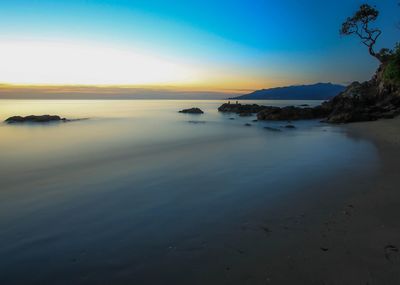 Scenic view of sea against sky at sunset