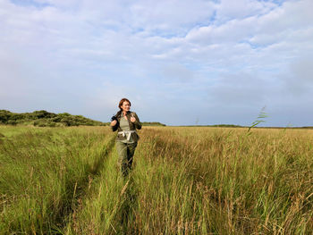 Man standing on field against sky