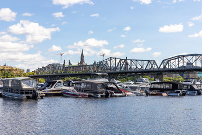 Bridge over river in city against sky