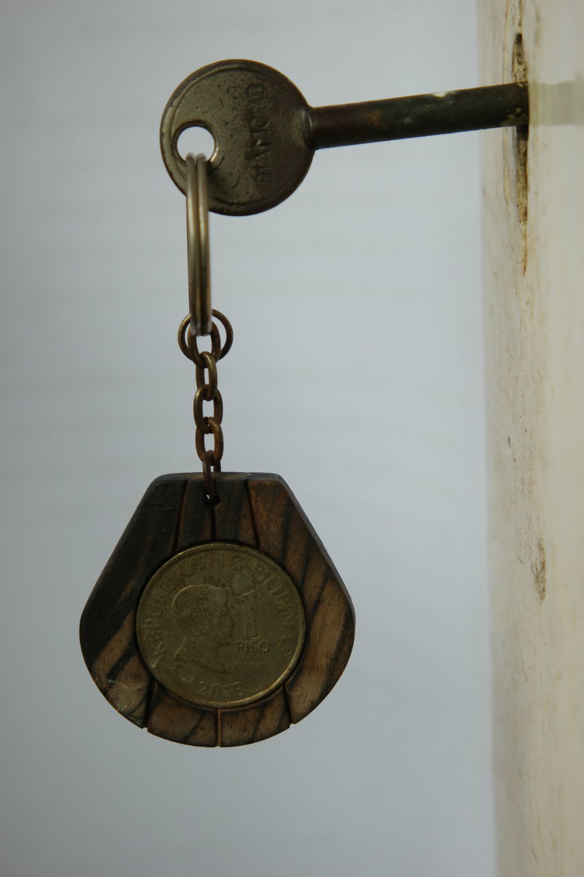 CLOSE-UP OF PADLOCKS HANGING ON METAL WALL