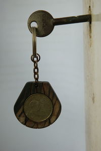 Close-up of padlocks hanging against wall