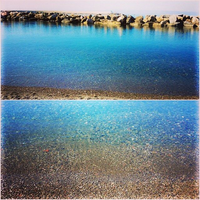 water, blue, sea, reflection, rippled, waterfront, tranquility, tranquil scene, nature, beauty in nature, scenics, high angle view, lake, outdoors, no people, idyllic, calm, day, built structure, sunlight