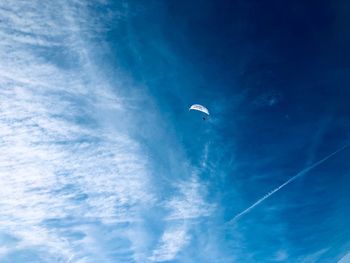 Low angle view of vapor trail against blue sky