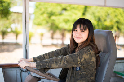 Portrait of young woman driving vehicle