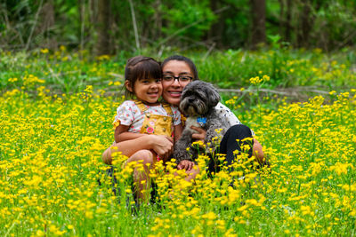 Portrait of smiling girl with yellow flowers