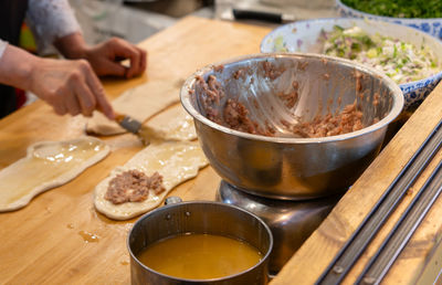 Midsection of man preparing food on table