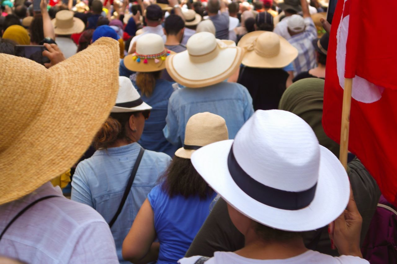 hat, group of people, crowd, real people, large group of people, men, clothing, rear view, adult, women, day, leisure activity, lifestyles, market, city, headshot, casual clothing, focus on foreground, street, spectator