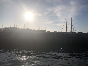 Scenic view of sea by buildings against sky