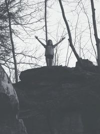 Woman standing on rock in forest