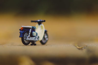 Close-up of toy motorcycle on road