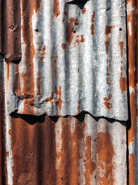 Old and rusty zinc sheet wall. vintage style metal sheet roof texture. pattern of old metal sheet. 