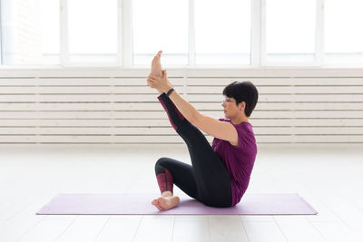 Woman with arms raised on floor