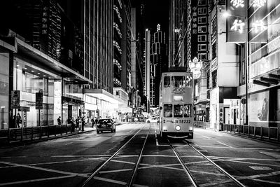 View of city street and buildings at night