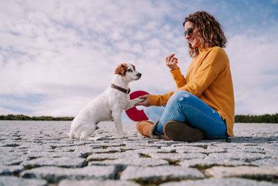 Man with dog sitting outdoors