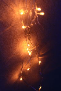 Low angle view of illuminated lights on street at night