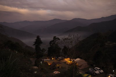 High angle view of illuminated mountains against sky at dusk