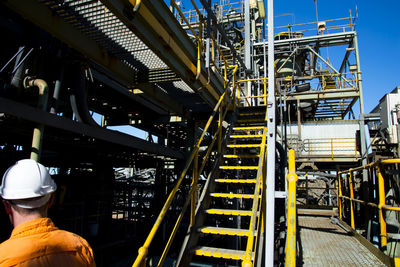 Low angle view of industry at factory against sky