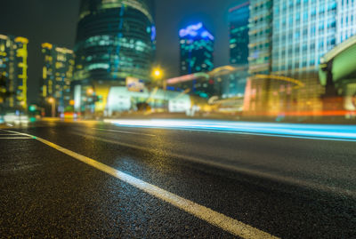 Illuminated city street and buildings at night