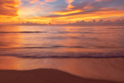 Scenic view of beach against sky during sunset