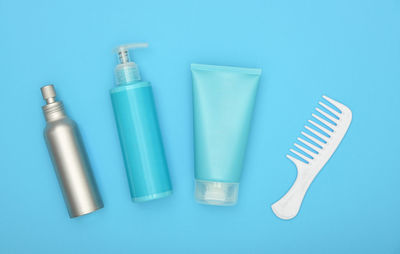 High angle view of glasses on table against blue background