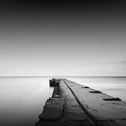 Pier amidst sea against sky