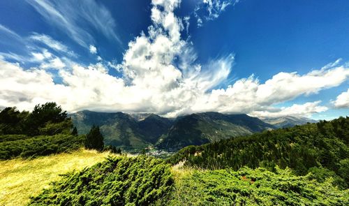 Scenic view of mountains against cloudy sky