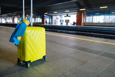 Rear view of woman walking on railroad station