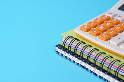 High angle view of multi colored pencils on table against blue background