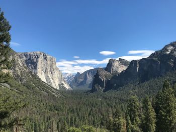 Scenic view of rocky mountains against blue sky