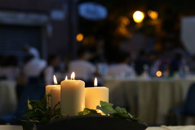 Close-up of lit candles in building
