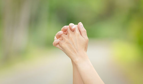 Close-up of woman hand against blurred background