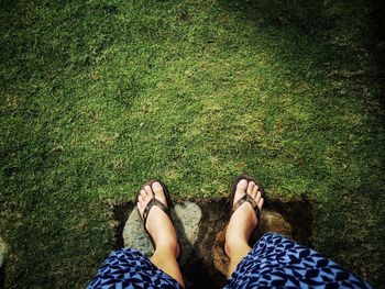 Low section of woman standing on field