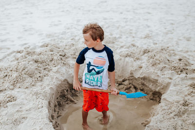 High angle view of boy toy on beach