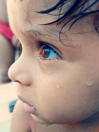 Close-up of wet boy looking away