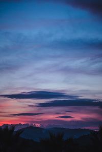 Scenic view of silhouette mountains against sky at sunset