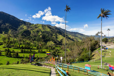 High angle view of people walking on mountain against sky