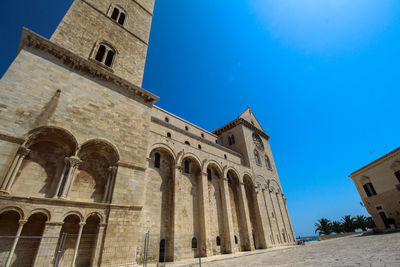 Low angle view of historical building against blue sky