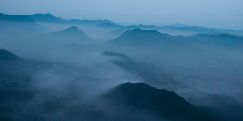 Scenic view of mountains against blue sky