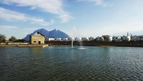 View of calm sea with buildings in background