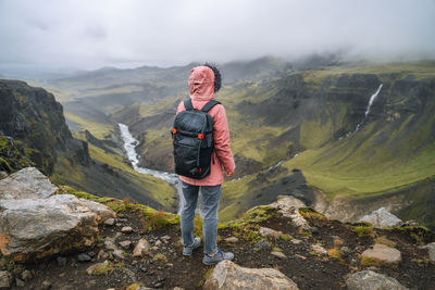 Full length of man standing on rock against mountains