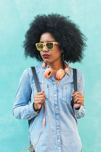 Portrait of young woman wearing sunglasses standing outdoors