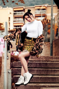 Full length of woman sitting outdoors