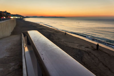 Scenic view of beach against sky during sunset